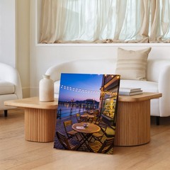 Cozy Outdoor Café Scene At Dusk, Featuring A Round Wooden Wall Art Canvas Print