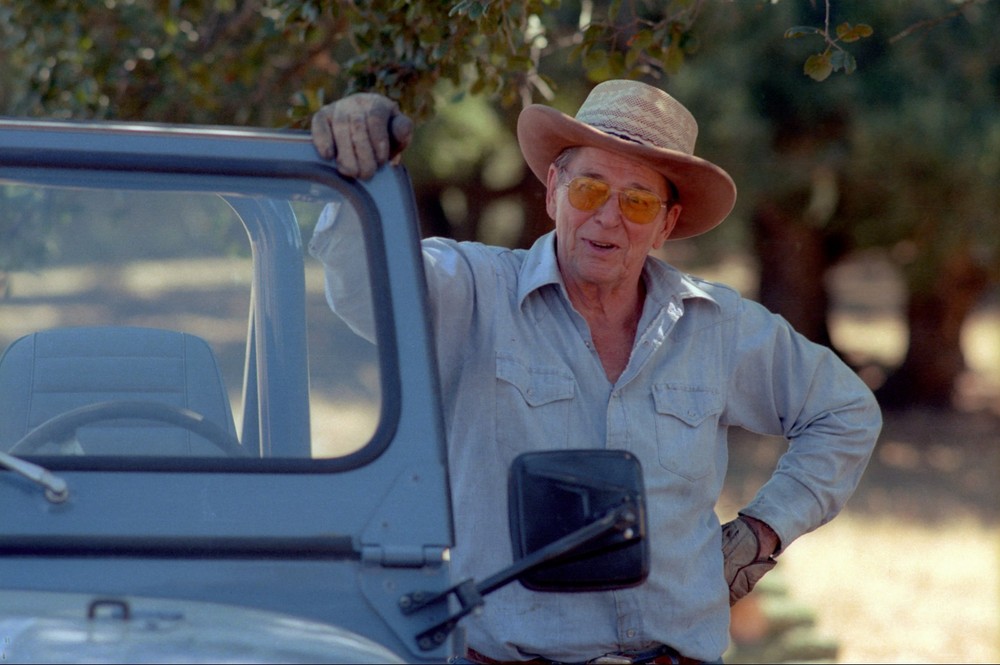 President Ronald Reagan leaning on a Jeep at his California ranch Photo Print