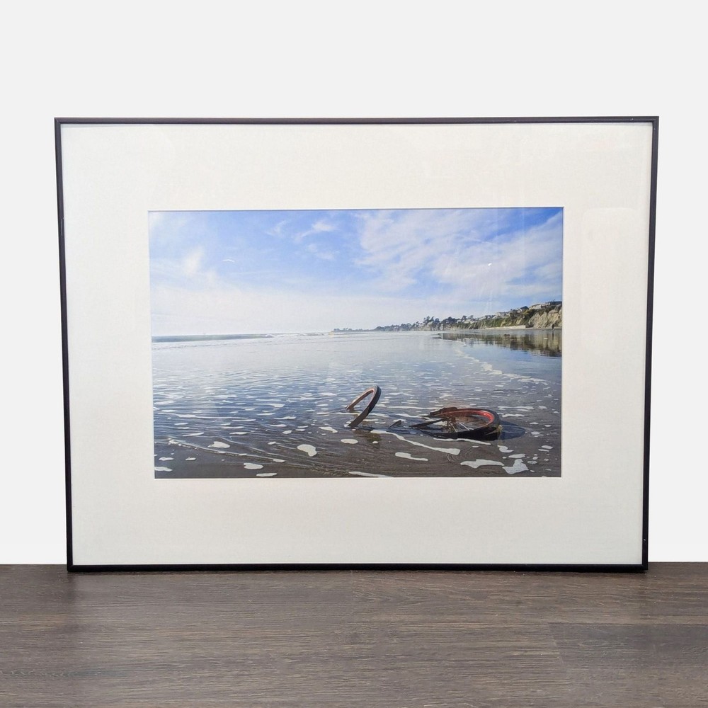 Framed Print – Abandoned Bicycle Wheel on Beach
