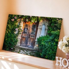 Beautifully Weathered Wooden Door Framed By Intricate Stone Archways Wall Art