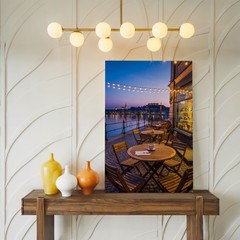 Cozy Outdoor Café Scene At Dusk, Featuring A Round Wooden Wall Art Canvas Print
