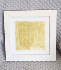 Yellow and White Geometric Print Wall Art Housed in a White Hard Plastic Frame